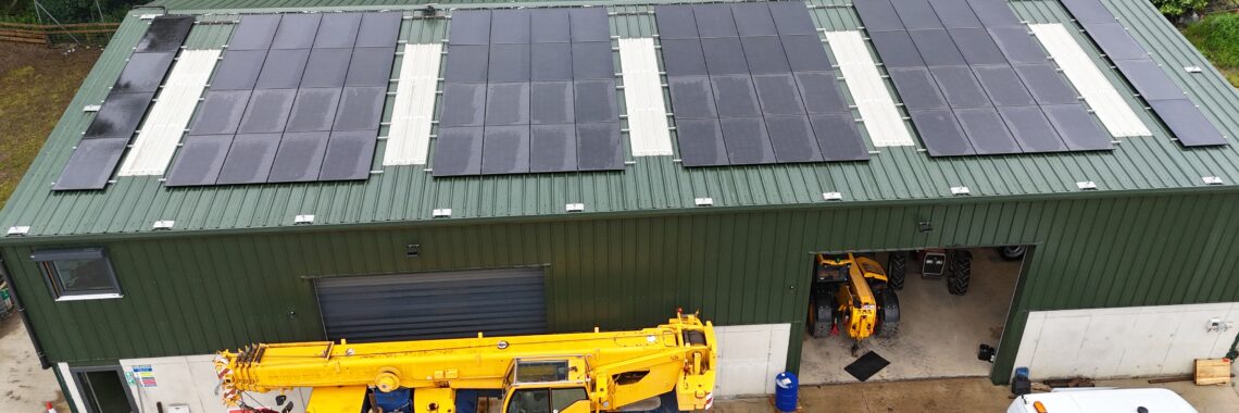 Aerial view of Park Hill Farm — the working fabrication and plant yard, with the rooftop solar array that powers the site, and a mobile crane, telehandler and van in the yard below