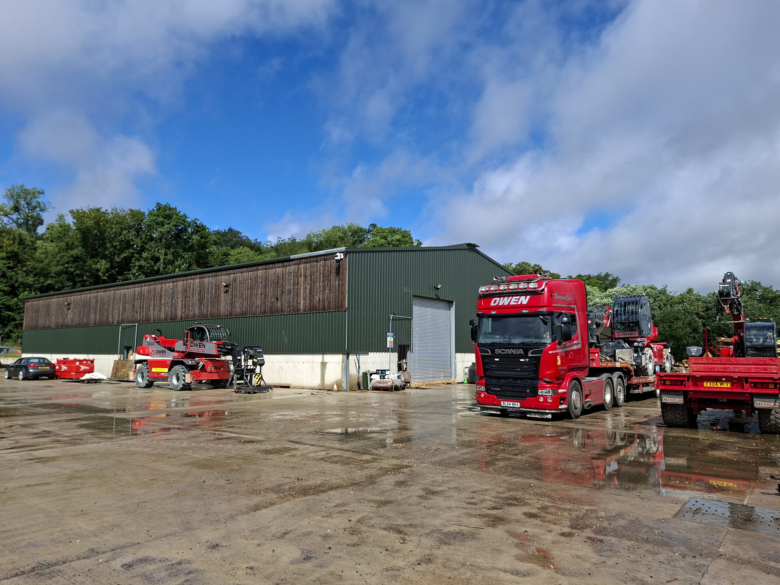 The working yard at Park Hill Farm at ground level — farm buildings, heavy plant and the fabrication business the system powers