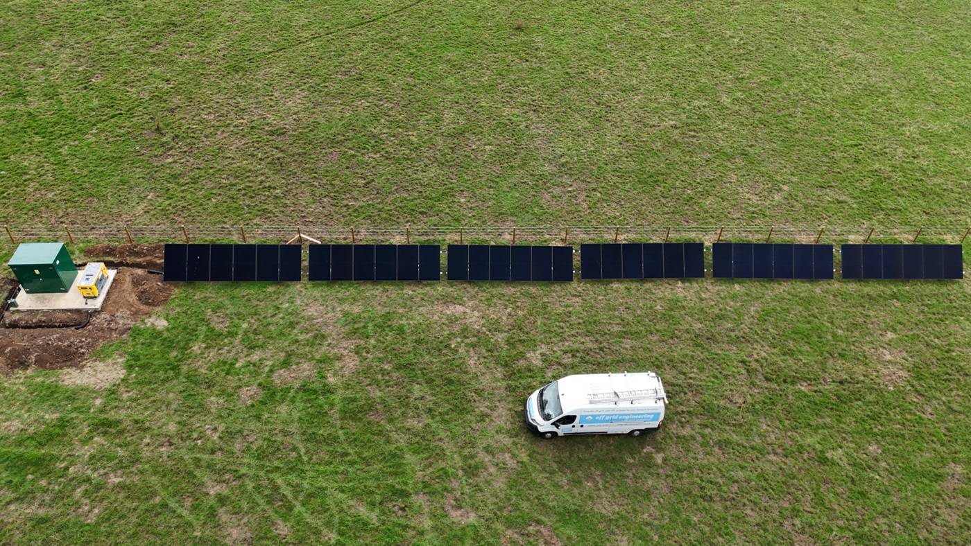 Ground-mounted solar array, plant room and generator on a rural plot, installed by Off Grid Engineering